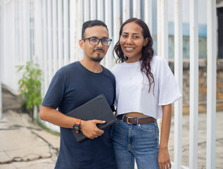 Pareja de jóvenes con tableta en mano con ropa casual 