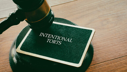 Intentional Torts Text on a Chalkboard with Judge's Gavel Representing Civil Law and Litigation