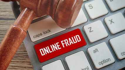 Close-Up of Gavel on Keyboard with Red Online Fraud Key Highlighting Cybercrime, Law, and Internet Security