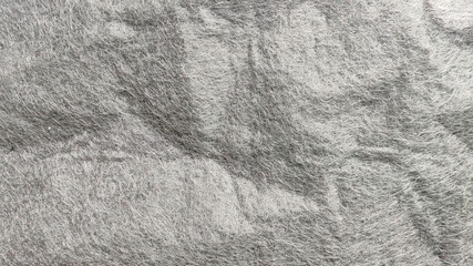 Wrinkled and Textured Gray Non-Woven Fabric Close-Up with Soft Fuzz Fibers and Shadow Folds
