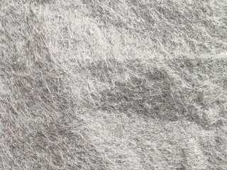Wrinkled and Textured Gray Non-Woven Fabric Close-Up with Soft Fuzz Fibers and Shadow Folds