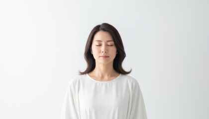 Inner Peace: A serene woman finds solace through meditation, eyes closed, embodying tranquility and mindfulness. This image conveys a sense of calm and the practice of achieving inner peace.