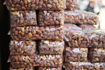 Packed snacks displayed at a market in daylight