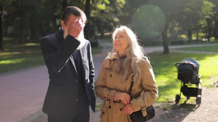 Elderly couple sharing a joyful moment outdoors together. - Powered by Adobe