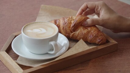 Enjoying coffee and croissant at a cozy cafe - Powered by Adobe