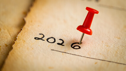 2026 Planning Note with Red Pushpin on Yellow Surface