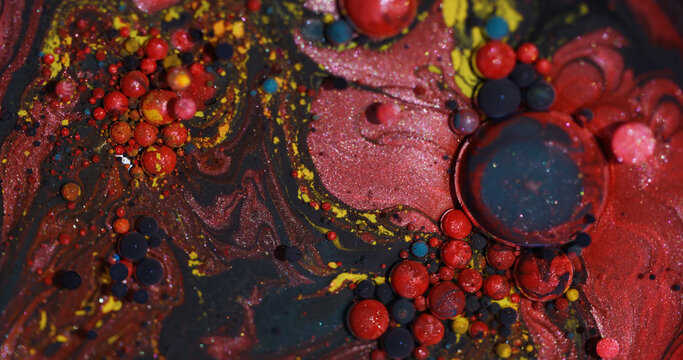 Color oil blend. Bubble art. Blur red yellow blue ink glitter droplet round texture acrylic wet pigment circle on abstract background.