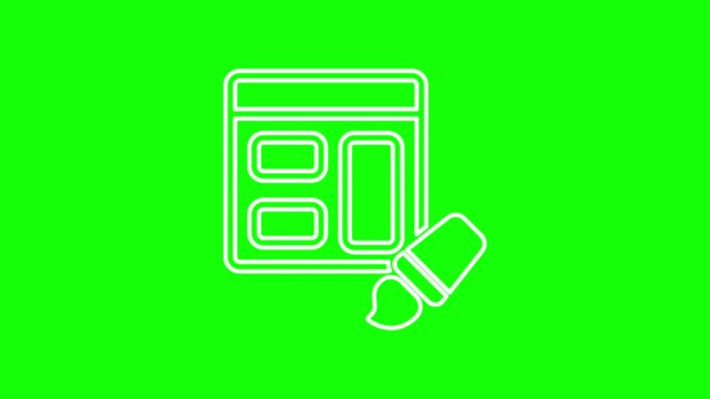 A web designer's display is on a green screen.