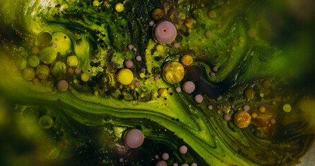 Ink stream. Acrylic bubbles. Defocused yellow green purple color oil sparkling texture round glitter liquid circle on abstract art bokeh background.