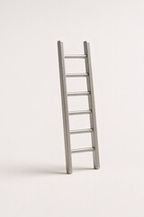 Small Metal Ladder Standing on Beige Background