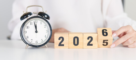 2025 end year to Happy New Year 2026 with vintage alarm clock. Christmas, New Start, Resolution, countdown, Goals, Plan, Action and Motivation Concept