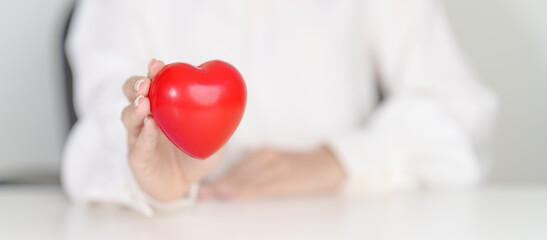 woman hand holding red heart shape. love, donor, September world heart day, world health day, CSR donation and Insurance concepts