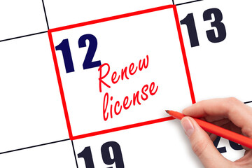 12 th day of the month. Hand writing Renew license reminder and drawing red frame on calendar with red pen on white background. Business concept. Planning and scheduling.