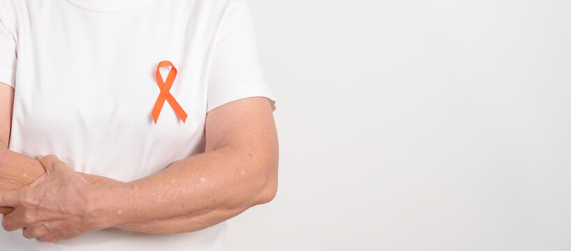 Elderly with Orange Ribbon for September Leukemia, March Kidney cancer day, Multiple Sclerosis, November Complex Regional Pain Syndrome, CRPS, COPD, Chronic Obstructive Pulmonary disease concepts - Powered by Adobe