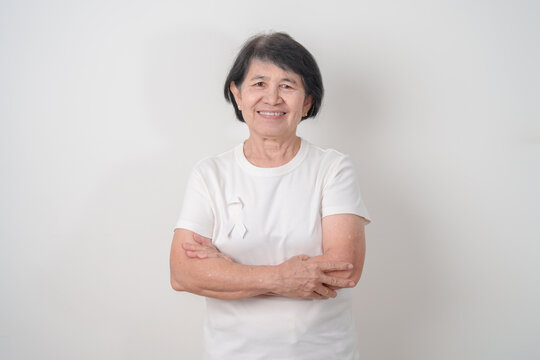 Elderly with White ribbon for concept November Lung Cancer Awareness month, Stop Violence Against Women, Adoption, May Retinoblastoma, Action for Women Health, March Remembrance, October Osteoporosis