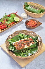 Grilled rice with fried potatoes and liver, wrapped in banana leaves, a traditional Indonesian dish