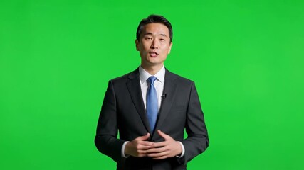 Asian Businessman Presenting on Green Screen Background. - Powered by Adobe