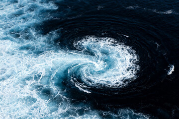 Ocean water swirl with white foam