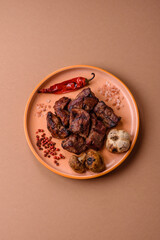 Beef, grilled meat in pieces, or kebab with sauce and vegetables. Beef in pieces