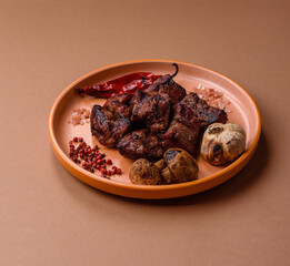 Beef, grilled meat in pieces, or kebab with sauce and vegetables. Beef in pieces