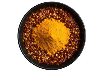 Overhead shot of turmeric powder and chili flakes in a black bowl isolated on transparent background