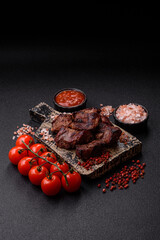Beef, grilled meat in pieces, or kebab with sauce and vegetables. Beef in pieces
