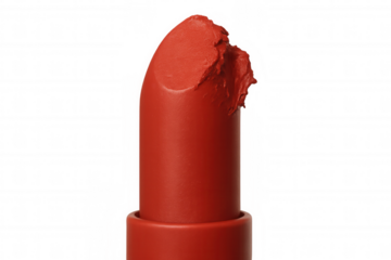 Broken red lipstick bullet showing rough texture and matte finish, beauty product with transparent background