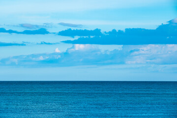Nature of the ocean and blue sky Summer with sunshine, sandy beaches, clear blue waters sparkling against the blue sky. on an island with good ecology and environment Background for summer vacation