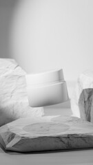 Elegant 3D render of a floating white cosmetic jar among natural stones. Minimalistic product mockup design for skincare, beauty branding, or luxury cosmetic presentation visuals.