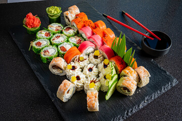 A beautifully arranged sushi platter features various rolls and garnishes, enticing food lovers