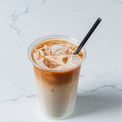 Iced coffee with rich espresso and milk rests on smooth marble, inviting enjoyment