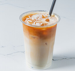 Iced coffee in a clear cup showcases rich espresso layers over creamy milk, perfect for warm days