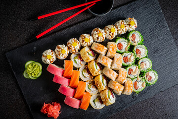 A vibrant assortment of sushi rolls beautifully displayed with wasabi and pickled ginger
