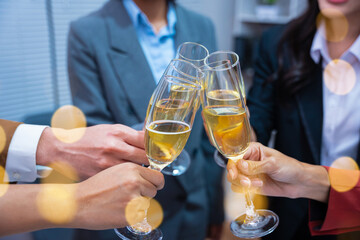 Happy group of business friends enjoying a party, celebrating with happy champagne glasses and sparkling wine, celebrating New Year at home.