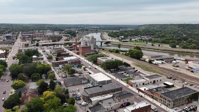 Aerial View of Historic Downtown in Mankato Minnesota, old buildings, grail silos, houses, trees, Minnesota river, overcast skies, North Riverfront Drive