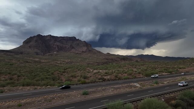 Static shot of Picketpost Mountain in Superior Arizona, Storm Clouds in sky, US Highway 60 in foreground, Monsoon in desert