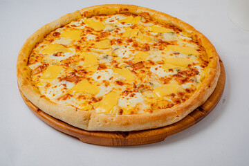 Delicious pizza sits on a wooden board, showcasing melted cheese and a fluffy crust, ready to enjoy