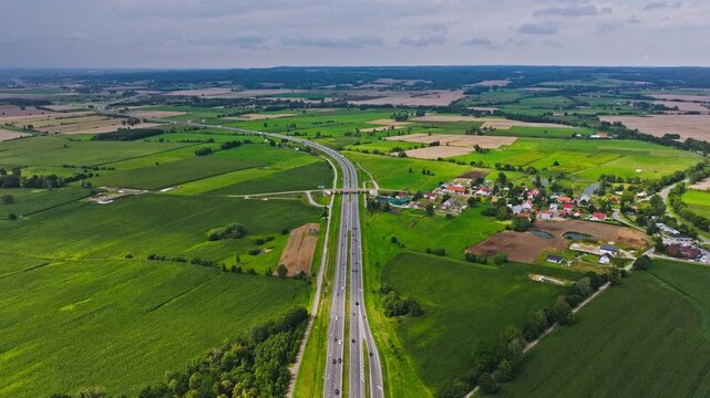 Cinematic drone establishing view of highway, Paslek Poland, cloudy landscape