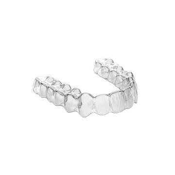 Clear plastic invisible dental aligner tray for orthodontic correction isolated on white background