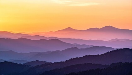 Obraz premium Sunset Over Layered Mountain Ranges with Orange and Purple Hues Majestic Landscape