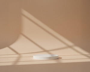 Minimalist product podium display on a warm beige background with natural window shadows. Soft light and geometric patterns create a calm, modern aesthetic. Perfect for product showcases, cosmetic 