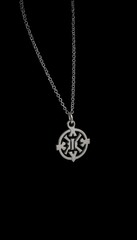 Silver pendant necklace with intricate design on black background  
