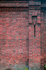 Fragment of a brick wall of a historic building on an autumn day