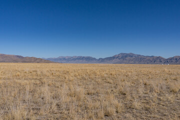 Fototapeta premium Pioneer Mountains with Lost River Range. U.S. Highway 20 (US 20) / U.S. Highway 26 (US 26) , Big Lost River Valley, near Arco, Butte County, Idaho. Snake River Plain. Basin and Range Province.