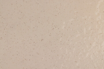 wet ceramic bowl with black and other small dots on the surface in water droplets, made of baked clay and painted in light paint wet food bowl