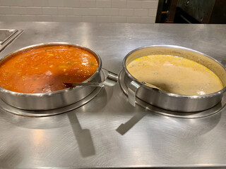 Pots of soup, buffet style. vegetable and creamy mushroom soup.