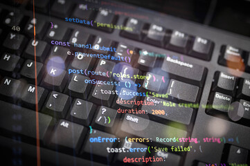 Close-up of colorful programming code overlay on black keyboard, representing modern software development, coding, and digital technology for web development, IT, or cybersecurity concepts.