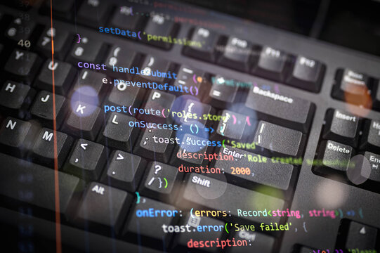 Close-up of colorful programming code overlay on black keyboard, representing modern software development, coding, and digital technology for web development, IT, or cybersecurity concepts.