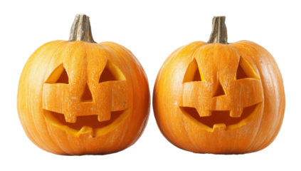 Two carved jack o lanterns with smiling faces on transparent background