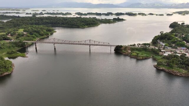 4k aerial video footage, flying across Bayano Lake, with "Puente Sobre El Bayano" bridge and "Carretera Interamericana" highway connecting peninsula Akua Yala in Babita de Perro with mainland Panama